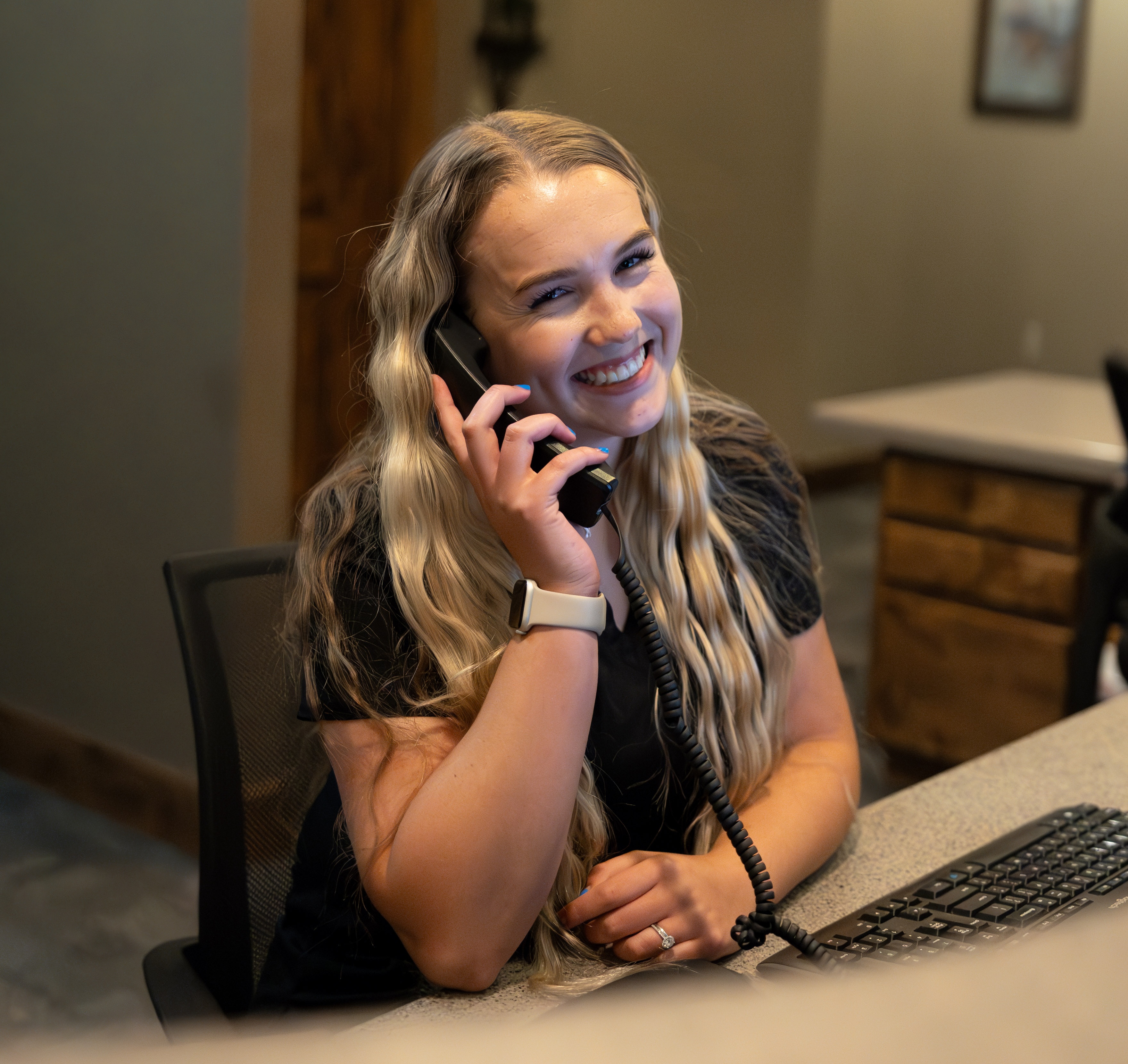 A friendly receptionist ready to help you schedule your visit at Coalville Dental.
